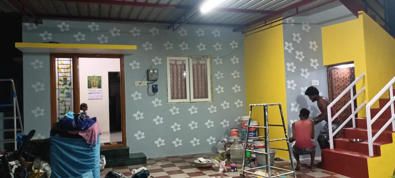 Interior wall with white floral stencil motifs on grey and yellow accents