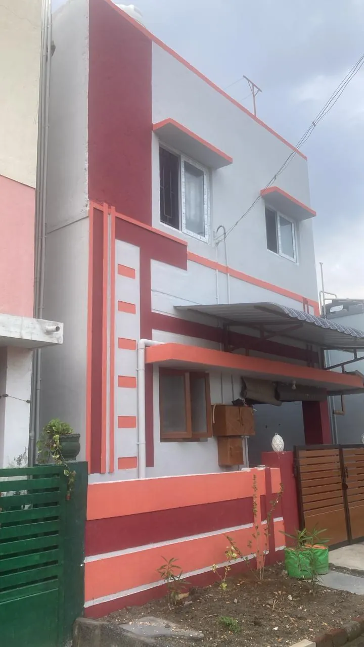 Residence exterior painted in white with deep red banding