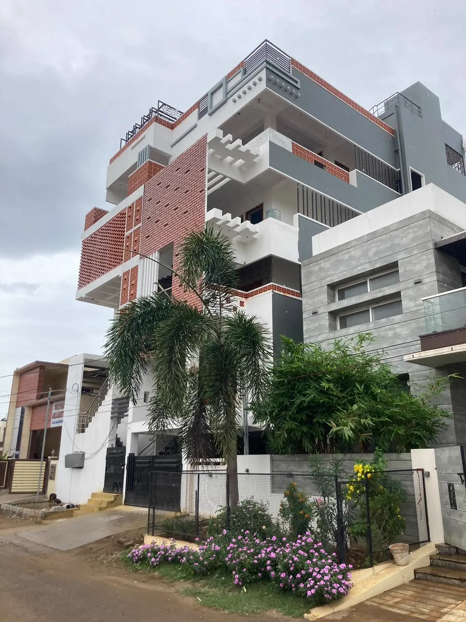 Contemporary villa exterior in brick red, grey and white